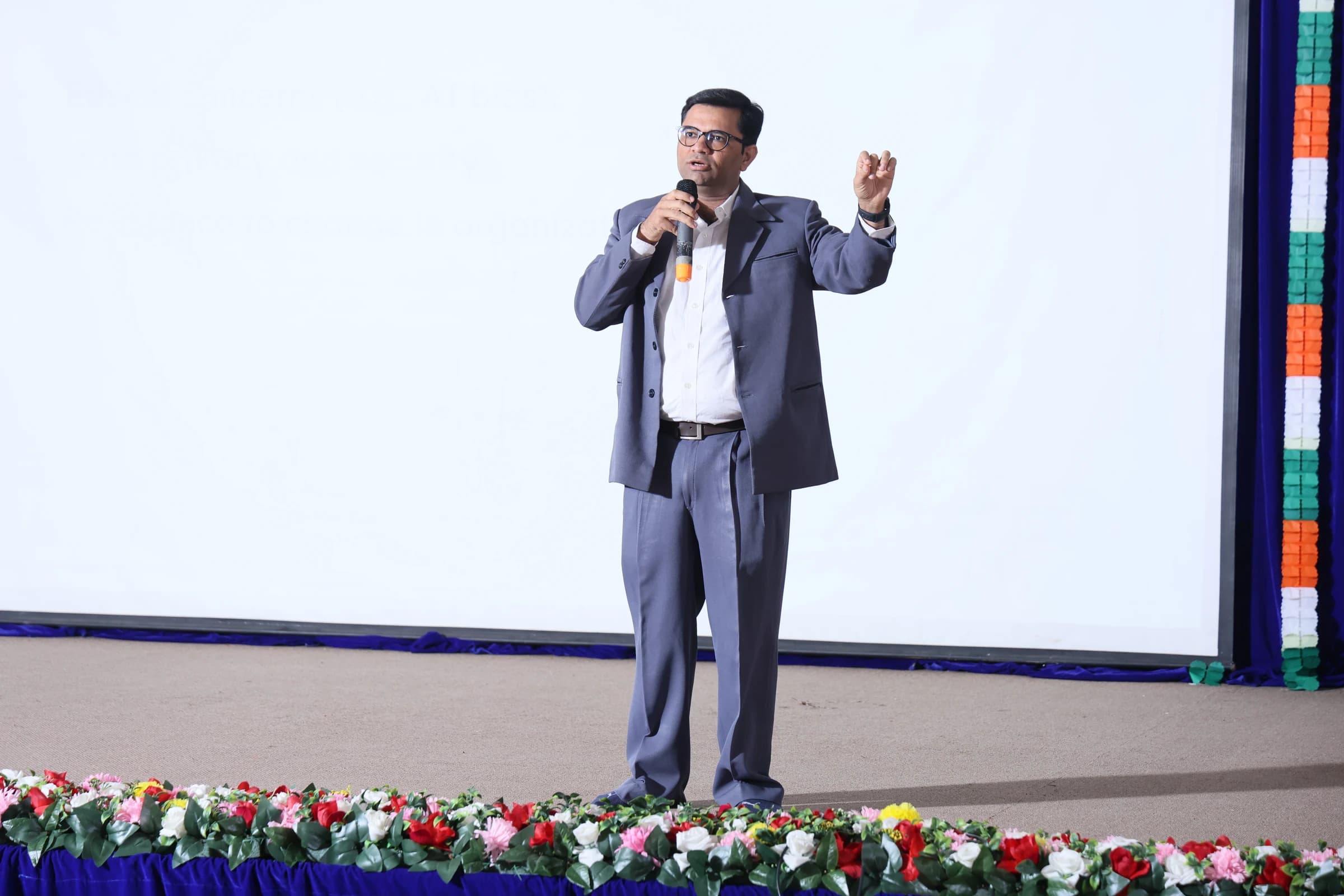 Madhav Anadkat mid-keynote — mic gesture, clean stage